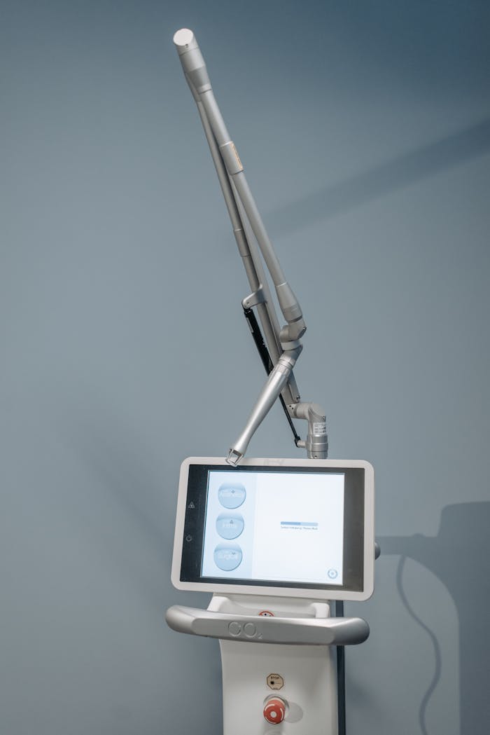 High-tech laser device used in medical procedures, featuring a digital screen, photographed indoors.